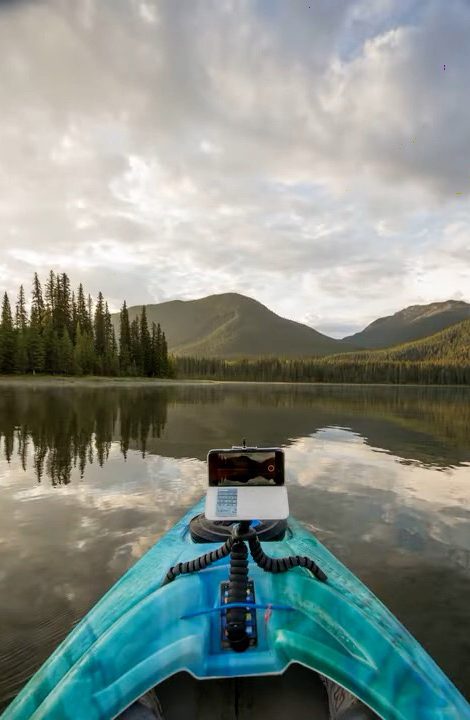 A kayak gliding across glassy Rock Lake toward the mountains
