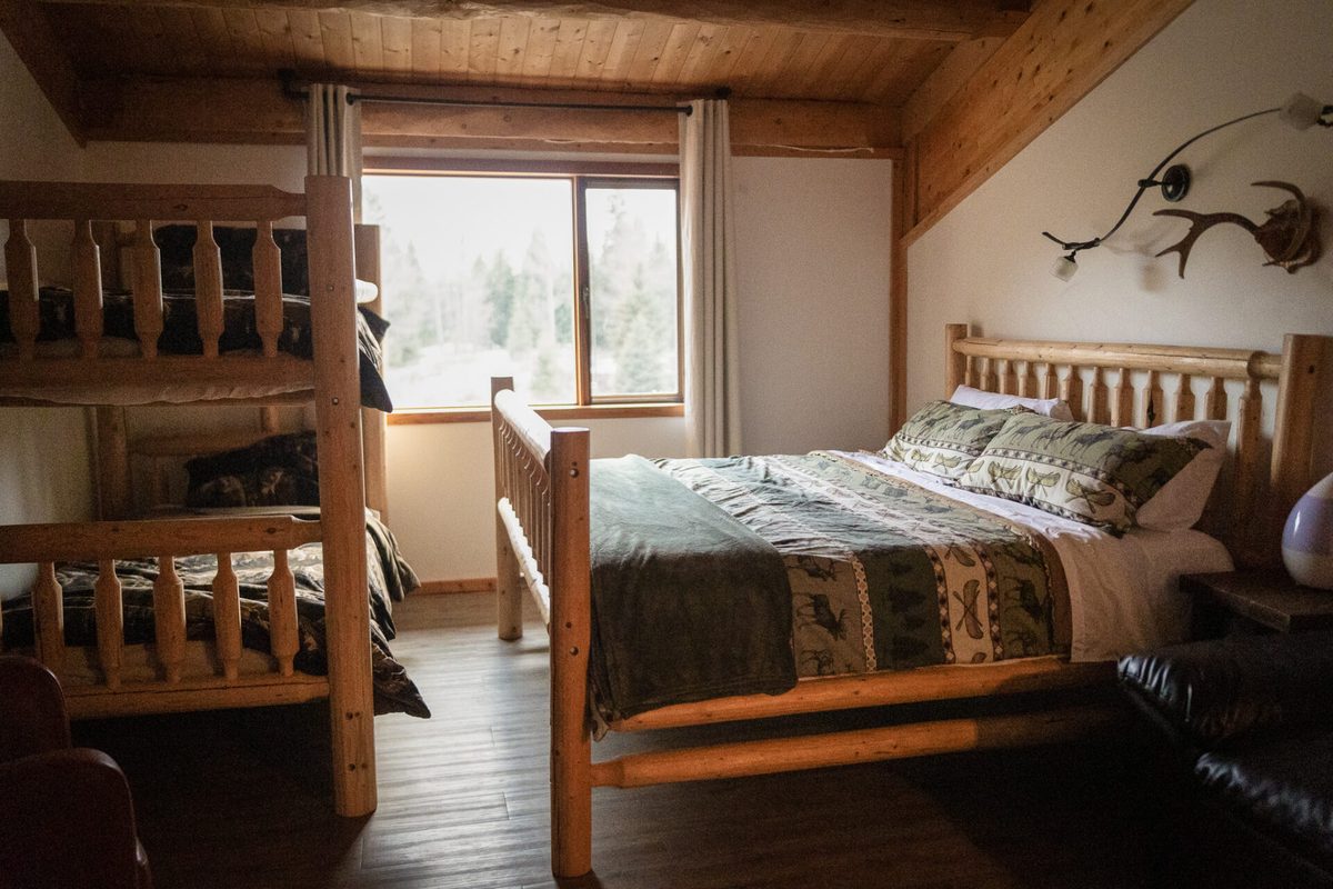 A King & Bunk suite with log furniture and forest windows