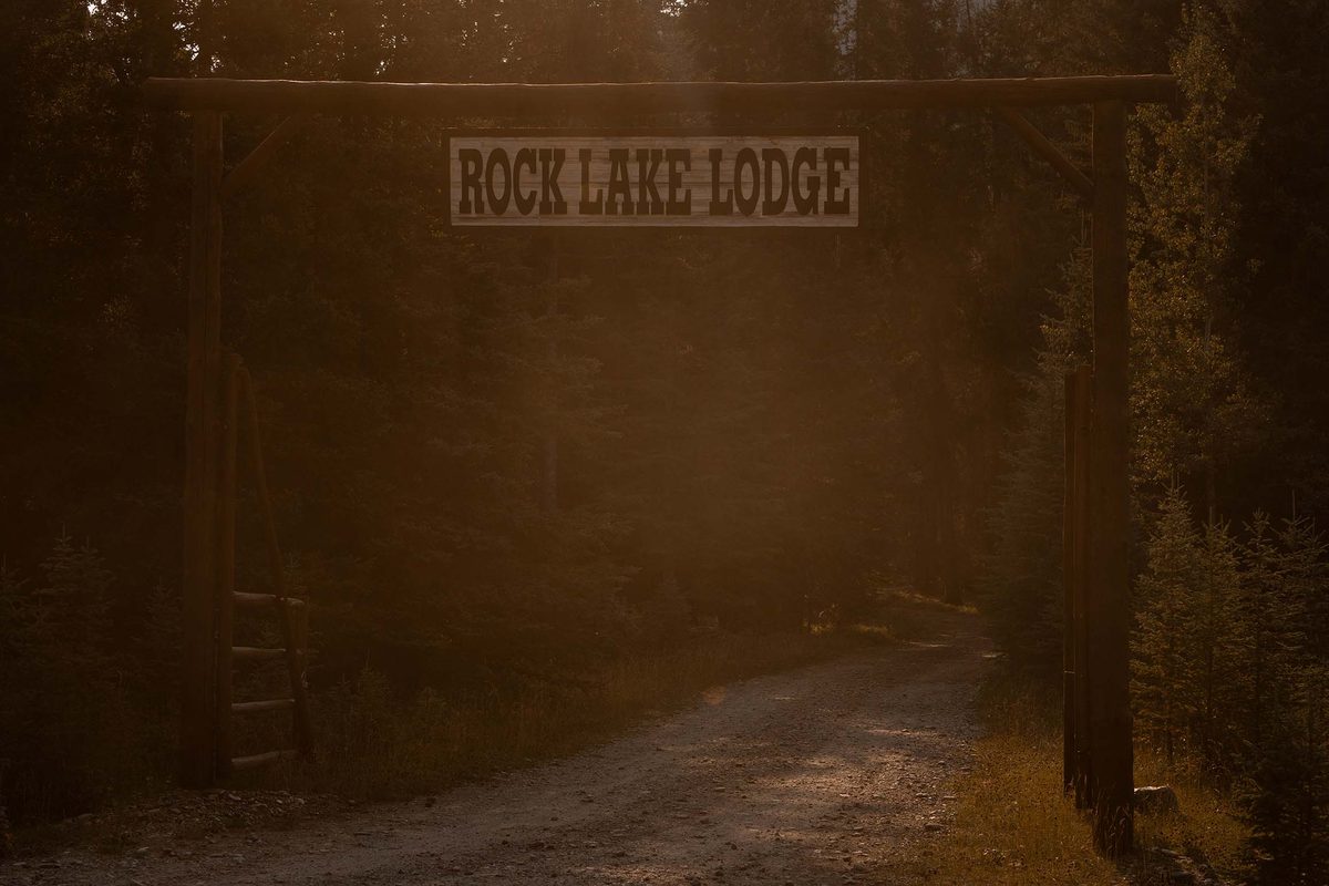 The Rock Lake Earth Lodge sign at the property entrance