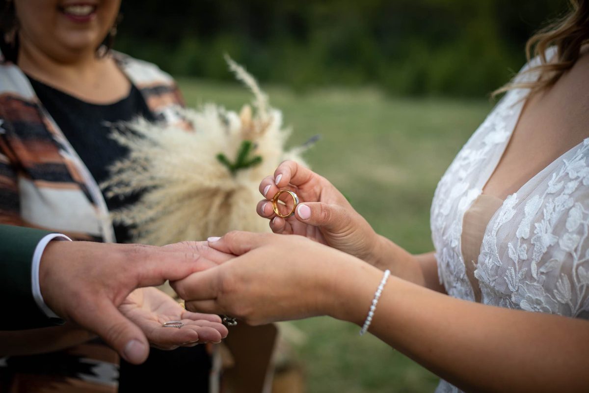 An officiant with a couple at the altar